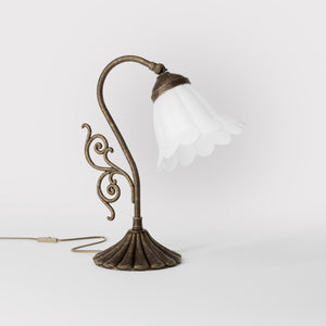 Art Deco table lamp with glossy white mushroom glass shade, sculpted brass base with undulating motifs, Italian design by Ghidini 1849 - Finish: OAS Antique Brass