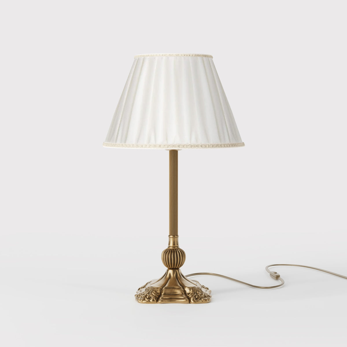 Baroque brass table lamp with decorative carved base and pleated ivory fabric shade with trims by Ghidini 1849 - Dimension/Finish: Medium / OBS Bronze Satin Brass