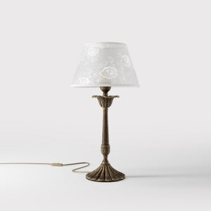 Classic brass table lamp with white fabric shade decorated with floral patterns, sculpted base with decorative elements by Ghidini 1849 - Finish: OAS Antique Brass