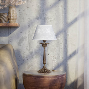 Classic brass table lamp with white fabric shade decorated with floral patterns, sculpted base with decorative elements by Ghidini 1849 - Finish: OAS Antique Brass