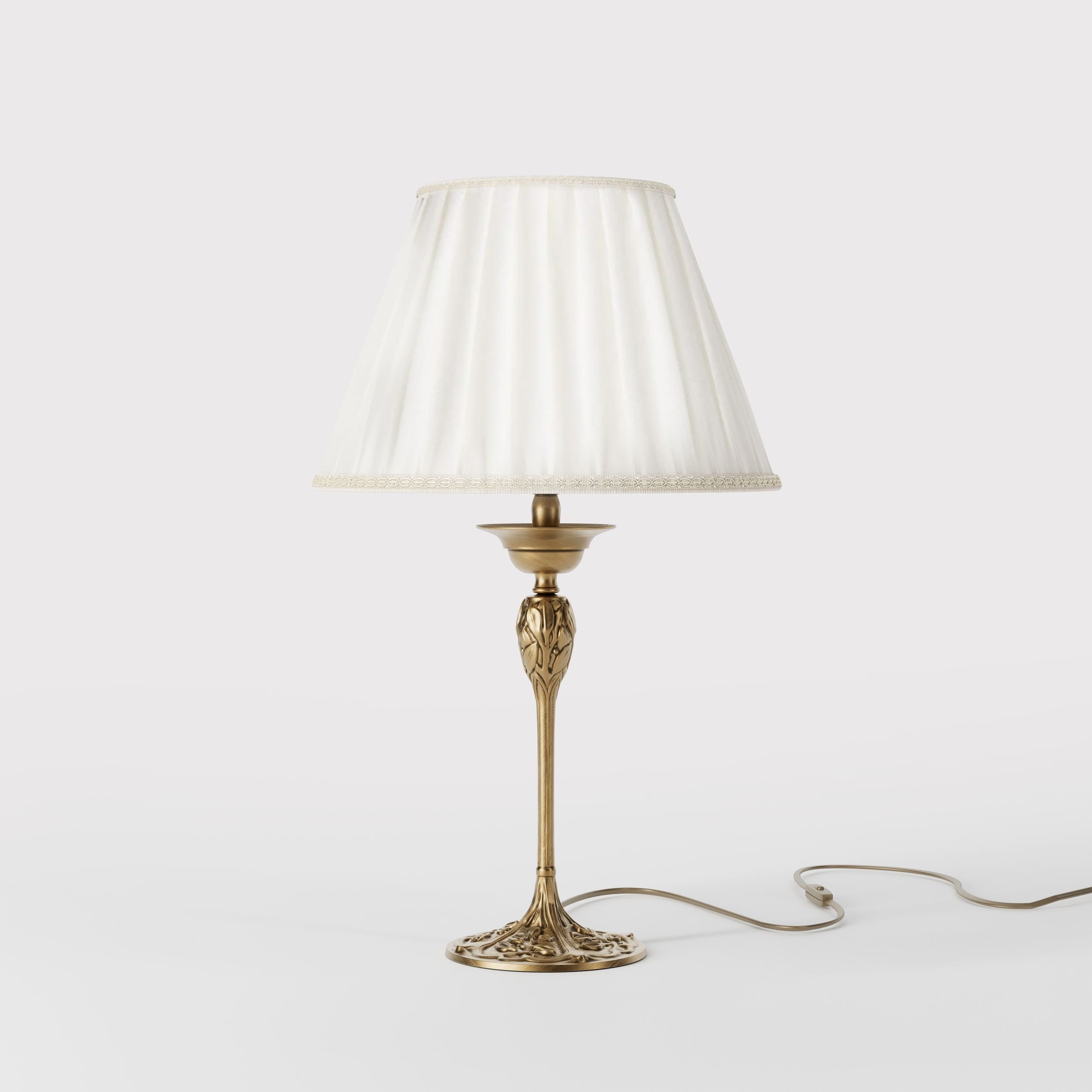 Art Nouveau table lamp Simona collection with decorated brass base featuring floral motifs and pleated ivory white fabric lampshade by Ghidini 1849 - Finish: OBS Bronze Satin Brass