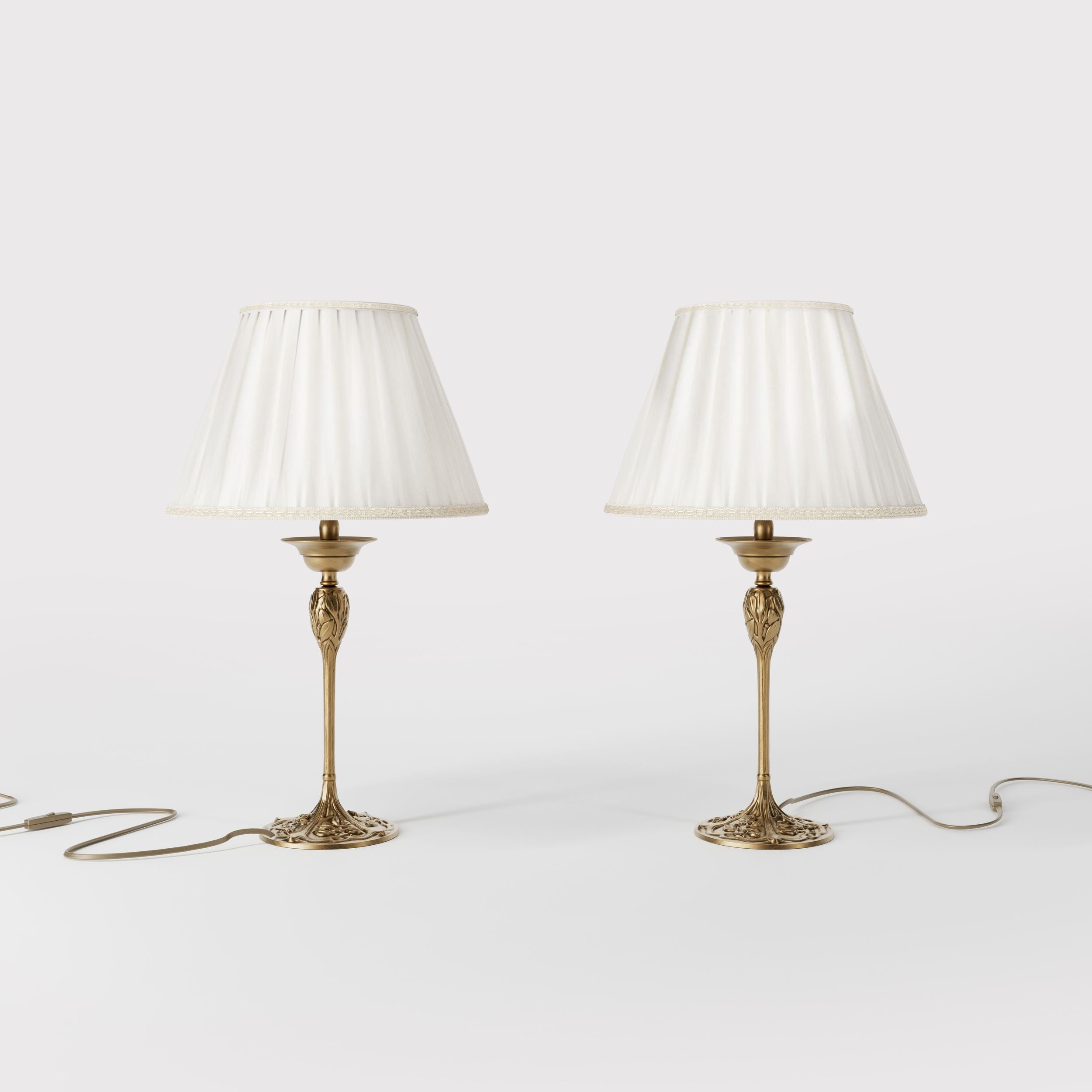 Art Nouveau table lamp Simona collection with decorated brass base featuring floral motifs and pleated ivory white fabric lampshade by Ghidini 1849 - Finish: OBS Bronze Satin Brass