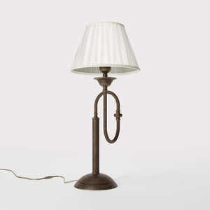 Brass table lamp with trombone-style design, ivory pleated shade, adjustable arm and decorated base, musical design Made in Italy by Ghidini 1849 - Finish: OAS Antique Brass