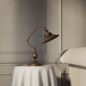 Rustic brass table lamp with curved arm and adjustable joint stepped turned base traditional conical shade by Ghidini 1849 - Finish: OAS Antique Brass