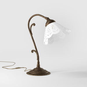 Art Nouveau table lamp with white pierced ceramic shade and decorative curved adjustable brass arm structure by Ghidini 1849 - Finish: OAS Antique Brass