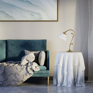 Art Nouveau table lamp with white pierced ceramic shade and decorative curved adjustable brass arm structure by Ghidini 1849 - Finish: OBS Bronze Satin Brass