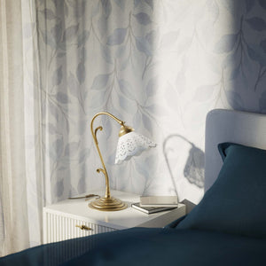 Art Nouveau table lamp with white pierced ceramic shade and decorative curved adjustable brass arm structure by Ghidini 1849 - Finish: OBS Bronze Satin Brass