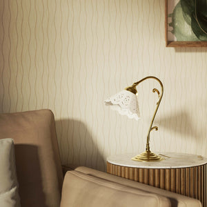 Art Nouveau table lamp with white pierced ceramic shade and decorative curved adjustable brass arm structure by Ghidini 1849 - Finish: OLV Polished Brass