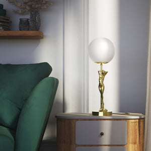 Brass table lamp with sculpted female figure and frosted glass globe, ideal for elegant interiors by Ghidini 1849 - Finish: OLV Polished Brass