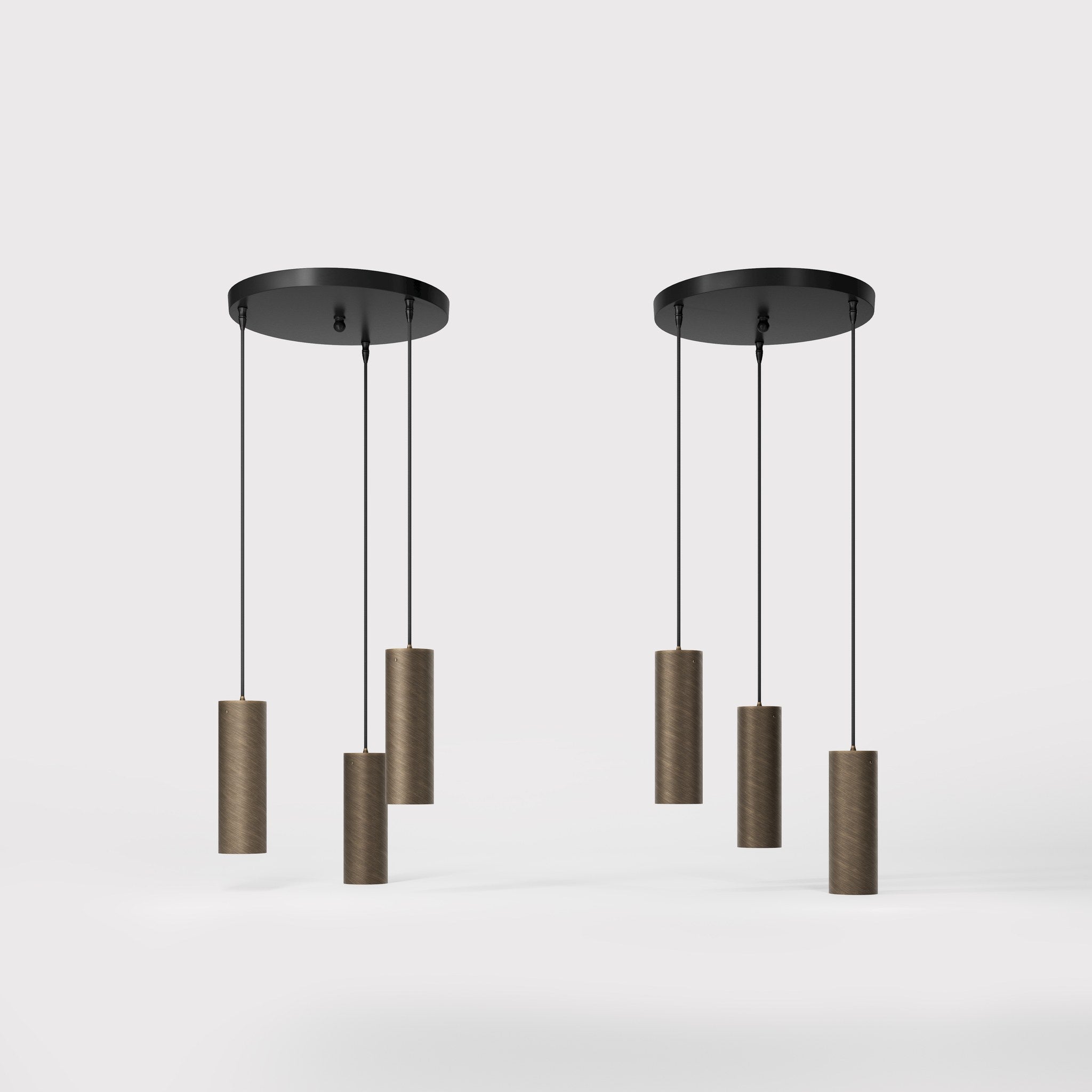Modern pendant lamp with three brass cylinders and round matte black iron base, height-adjustable pendants, Venere design collection by Ghidini 1849 - Finish: OBM Bronze Satin Matt Brass