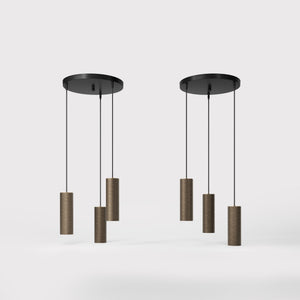 Modern pendant lamp with three brass cylinders and round matte black iron base, height-adjustable pendants, Venere design collection by Ghidini 1849 - Finish: OBM Bronze Satin Matt Brass