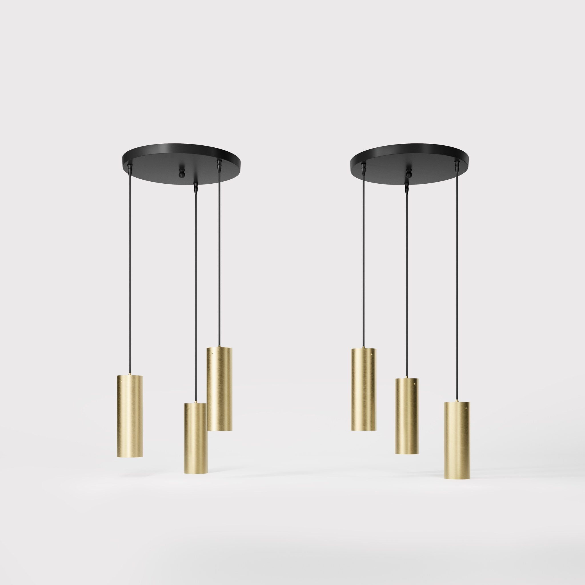 Modern pendant lamp with three brass cylinders and round matte black iron base, height-adjustable pendants, Venere design collection by Ghidini 1849 - Finish: OBV Bronze Satin Light Brass