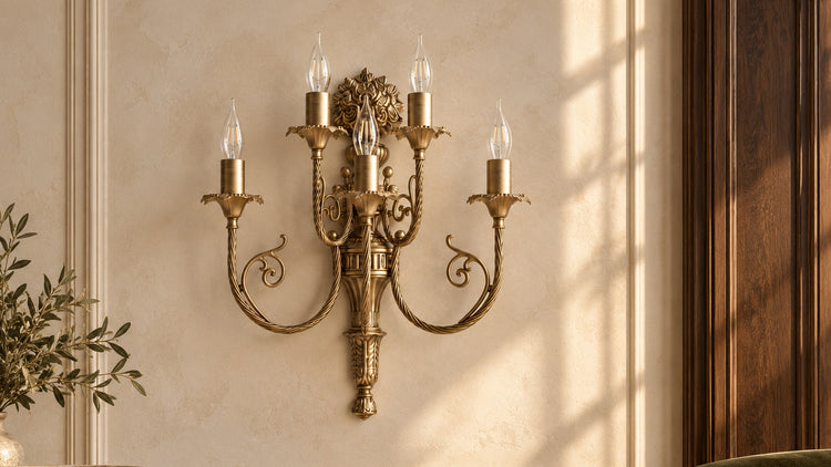Luigi XV brass wall lamp with five ornamental arms on an ivory wall