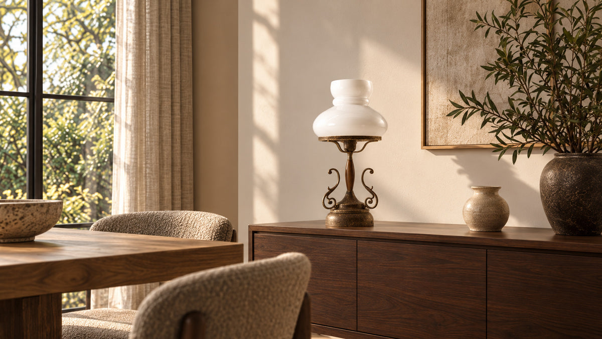 Mississippi antique brass table lamp with a white glass shade on a walnut sideboard in a sunlit dining room.