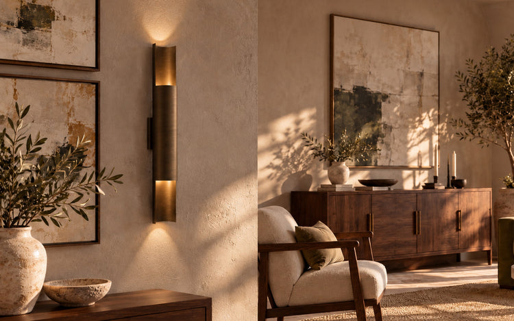 Venere wall lamp in satin bronze beside walnut furniture and abstract paintings